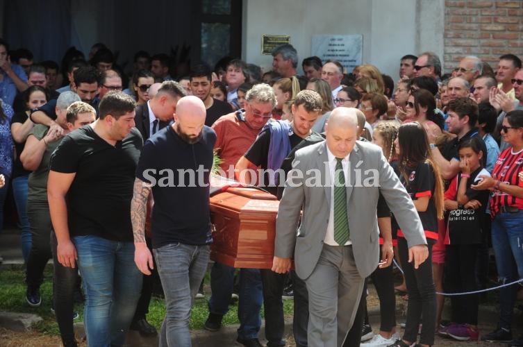 Familiares y amigos de Emiliano Sala llevan el féretro hasta el coche fúnebre, bajo una cortina interminable de aplausos. (Foto Clarín) 
