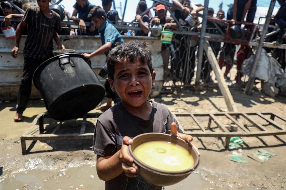 Un niño pide comida en Gaza.